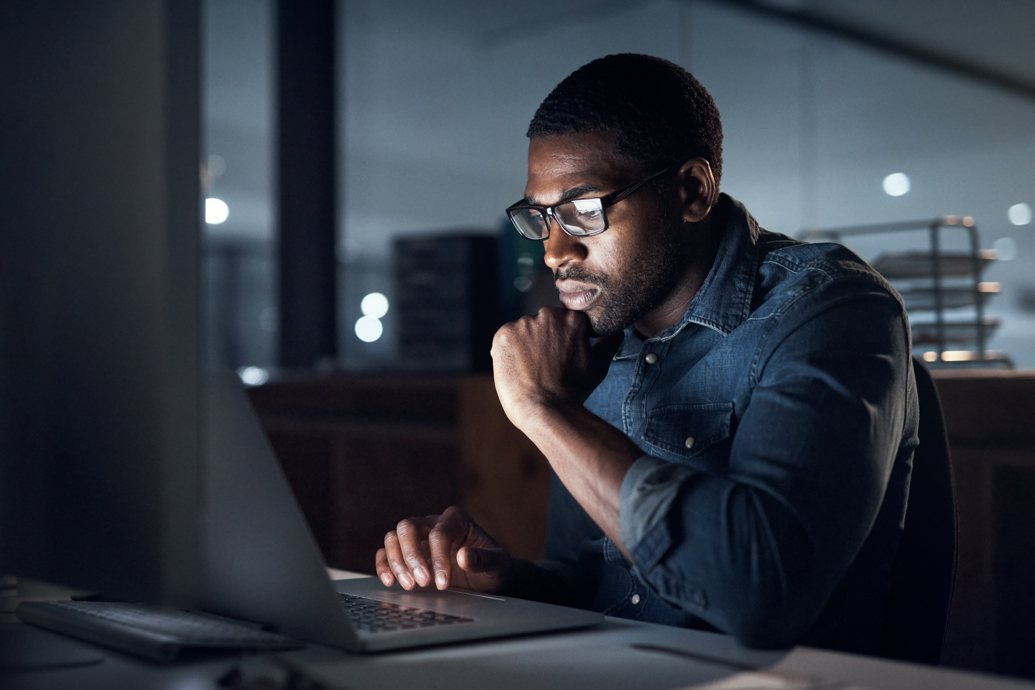Young man looking on computer trying to find a rehab center for his loved one