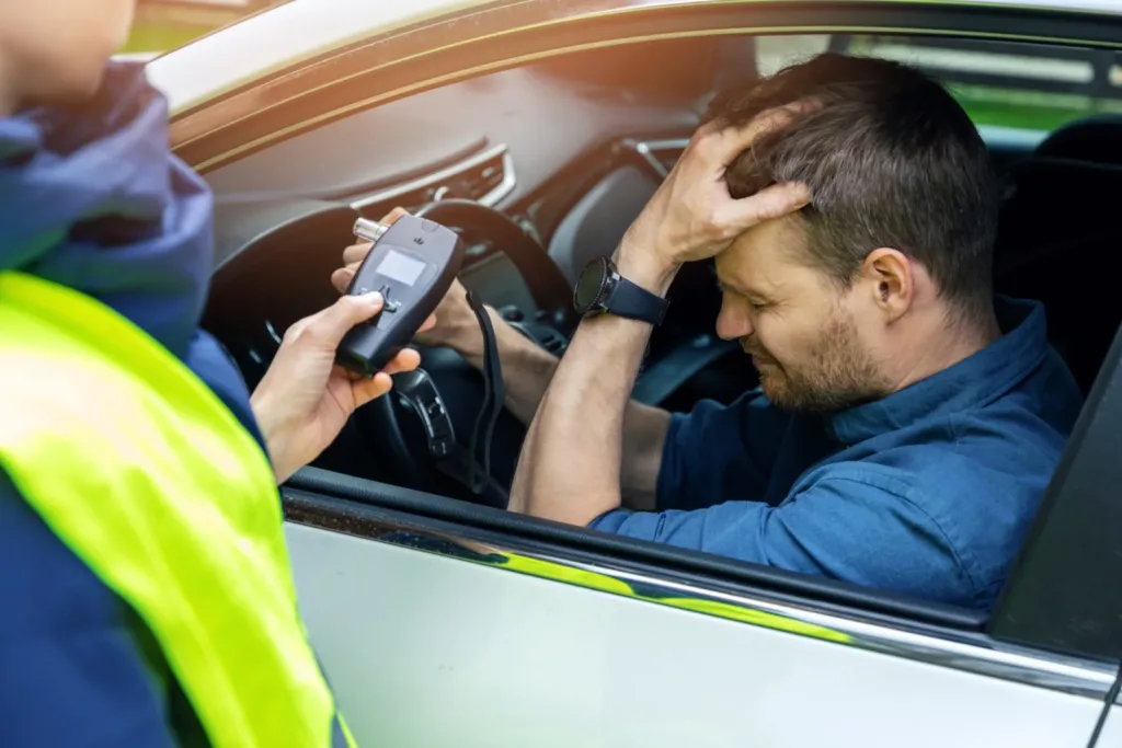 drink-and-drive-concept-sad-drunk-man-sitting-in-the-car-after-police-alcohol-test-with-alcometer
