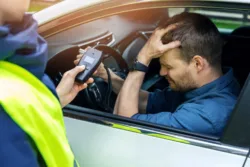 drink-and-drive-concept-sad-drunk-man-sitting-in-the-car-after-police-alcohol-test-with-alcometer
