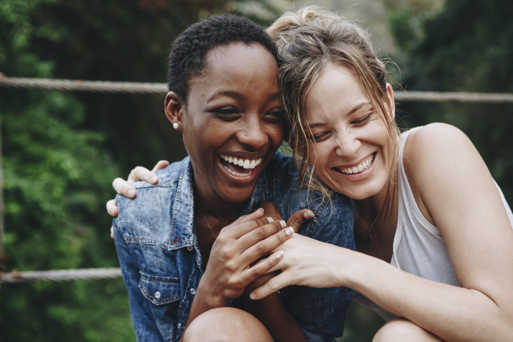 Happy friends holding each other