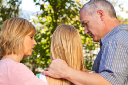 Parents talking with their teenage daughter about addiction