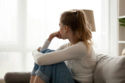 Woman Sitting Alone on Couch Thinking
