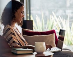 Woman Sitting on Couch on Computer