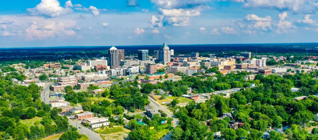 An aerial shot of the skyline of Greensboro located in North Carolina, USA, on a partly cloudy day