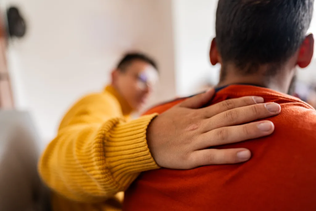 Close-up of psychologist with hand on patient's shoulder