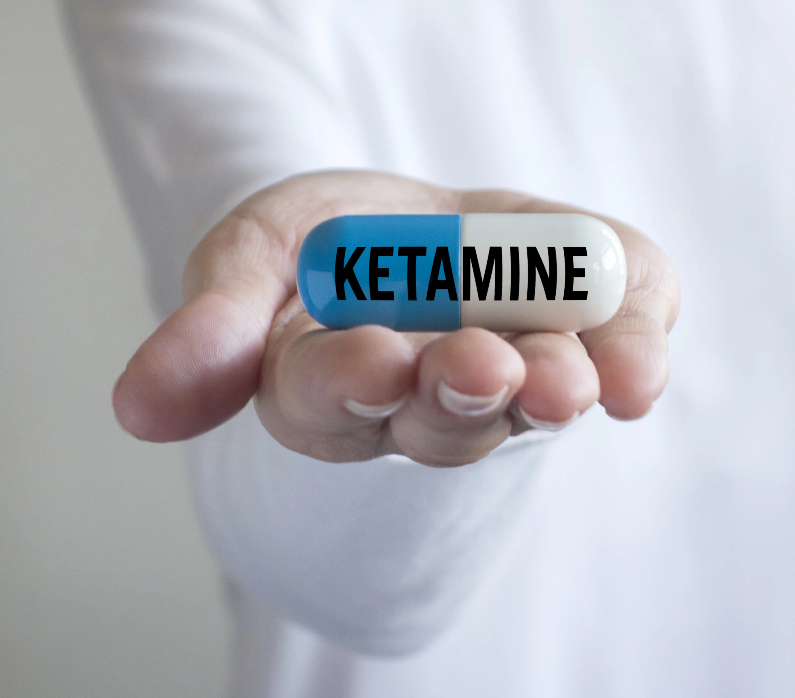Close up photo of a woman holding a ketamine medicine