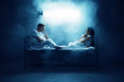 Crazy man and woman are sitting in bed, dark room on background. Psychedelics having problems every night, depression and stress, sadness, psychiatry hospital