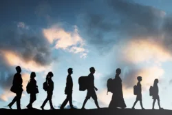 Silhouette Of Refugees People With Luggage Walking In A Row