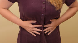 woman-holding-her-stomach-stomach-pain-in-the-middle-closeup-isolated-stockpack-gettyimages Woman holding her stomach, stomach pain in the middle closeup isolated