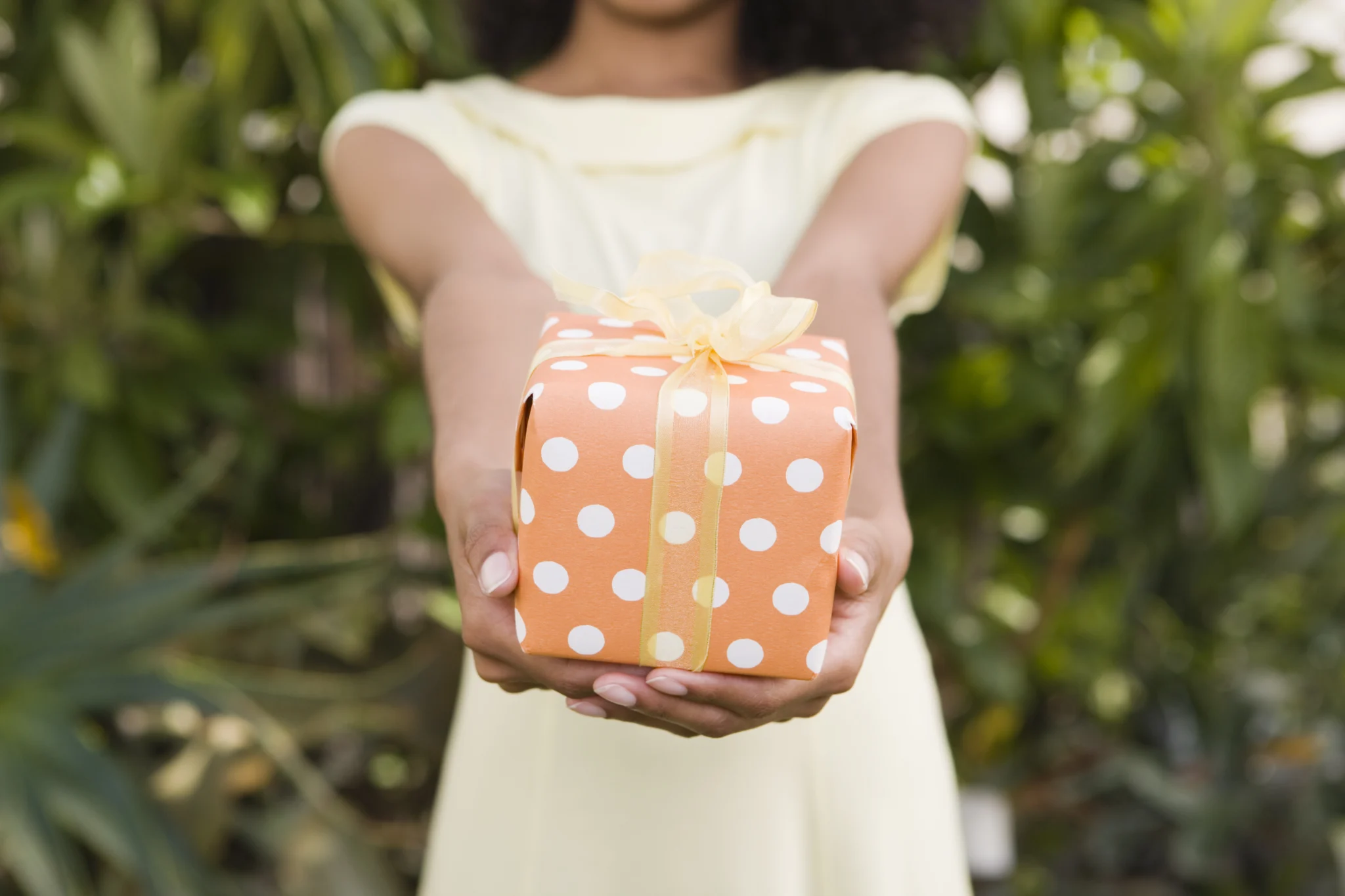 Woman holding present to give to a loved one celebrating sobriety