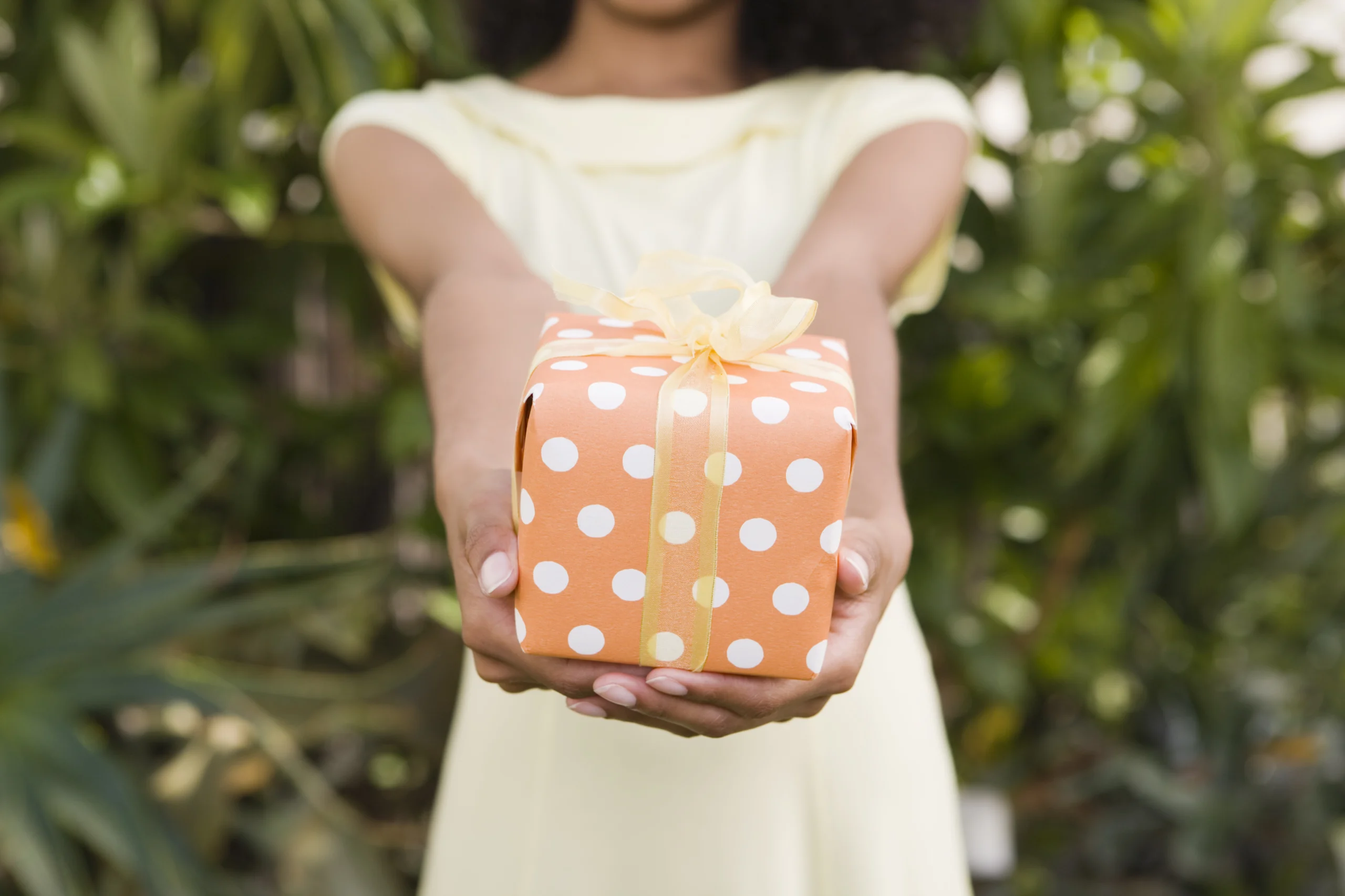 Woman holding present to give to a loved one celebrating sobriety