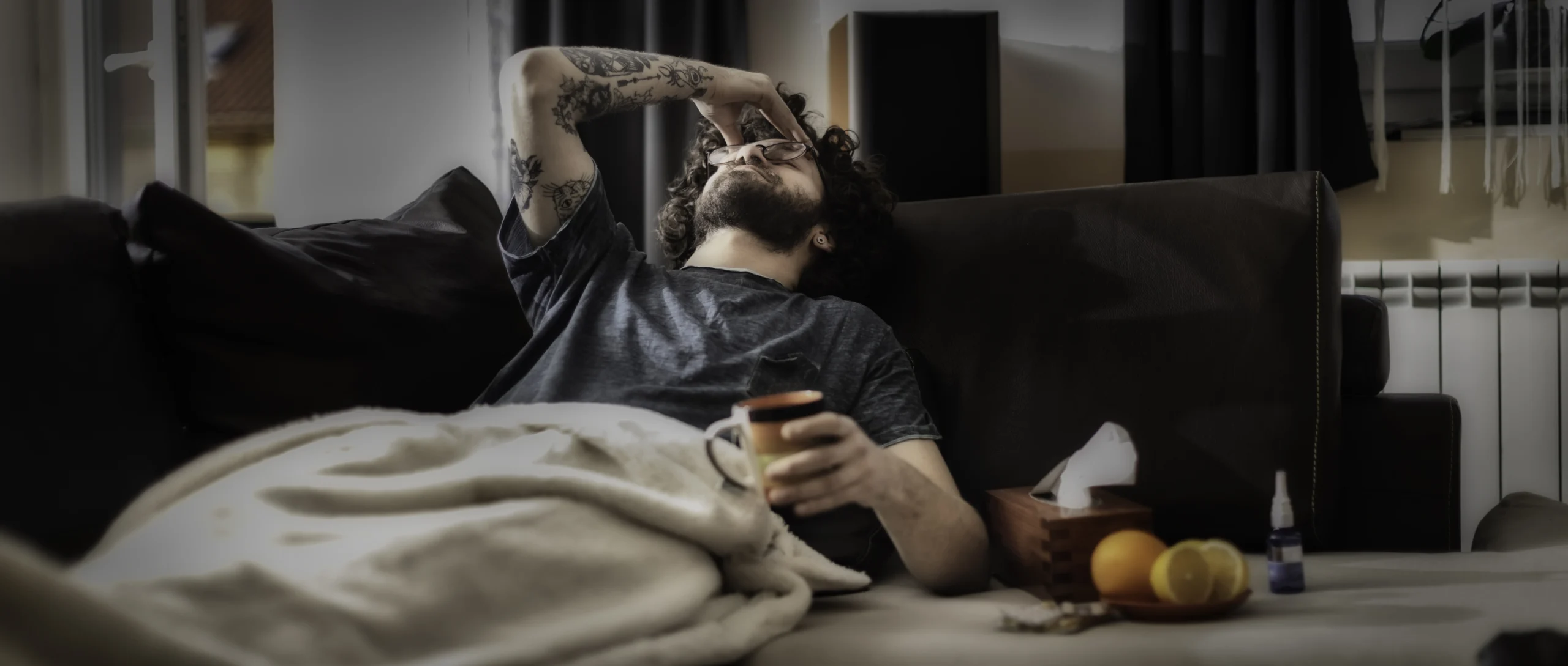 Young man suffering from headache, migraine or hangover at home